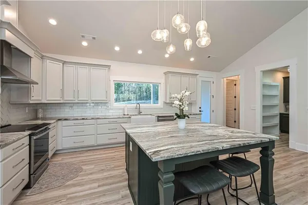 a kitchen with a sink stove and cabinets