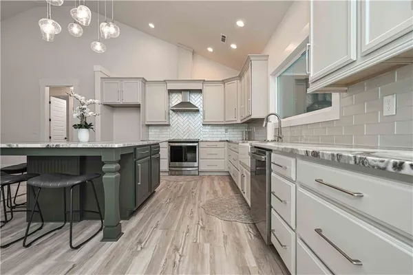 an empty room with wooden floor and ceiling fan