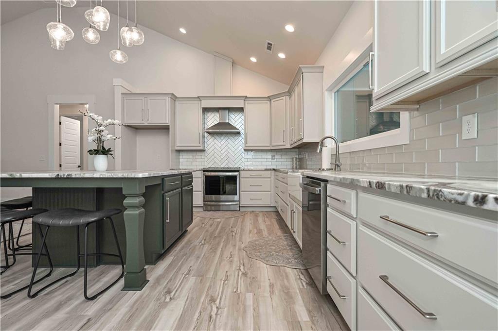 3667 Jones Mill Road Carrollton, GA 30116 - Photo 23 of 66 a kitchen with kitchen island granite countertop lots of counter top space and stainless steel appliances