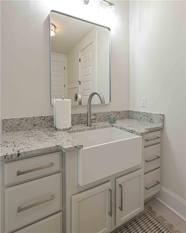 3667 Jones Mill Road Carrollton, GA 30116 - Photo 29 of 66 a bathroom with a granite countertop sink and a mirror
