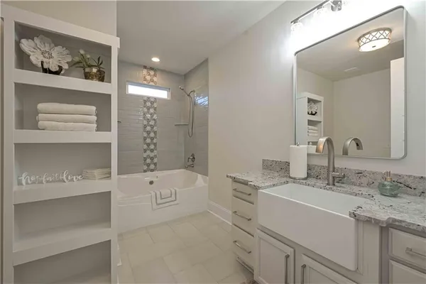 a kitchen with white cabinets and white appliances