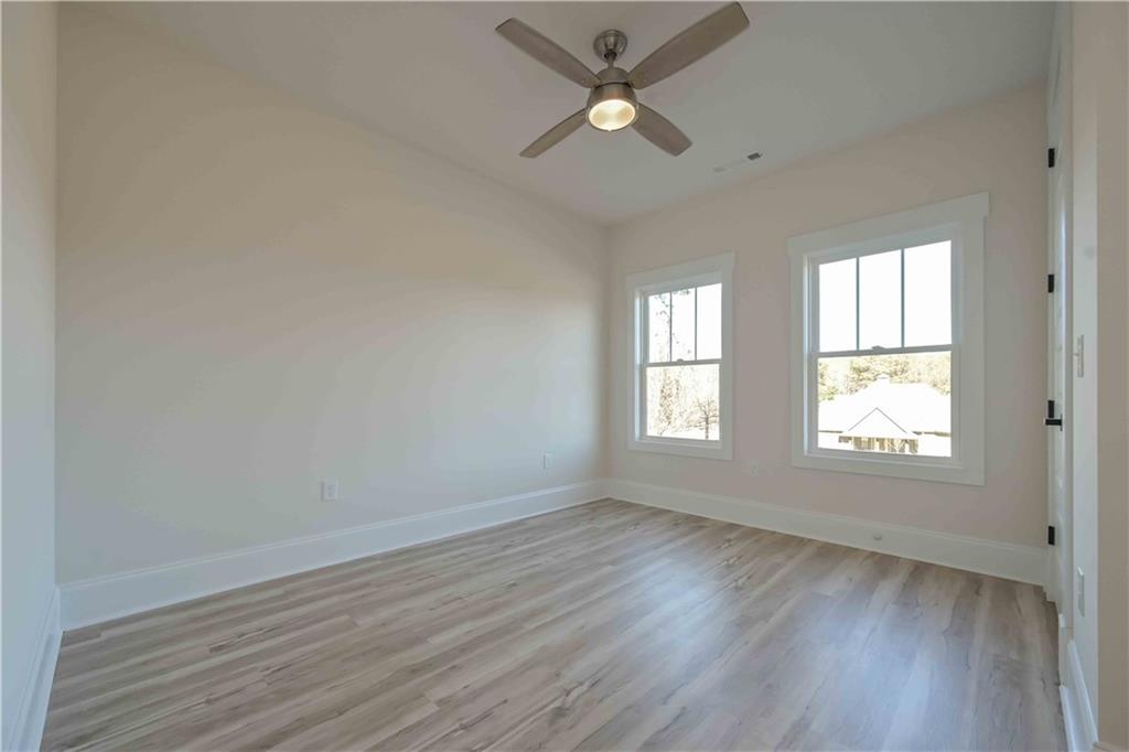 3667 Jones Mill Road Carrollton, GA 30116 - Photo 33 of 66 wooden floor in an empty room with a window