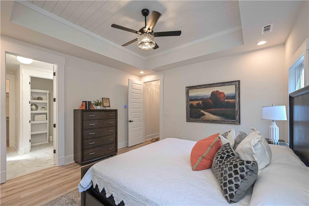 3667 Jones Mill Road Carrollton, GA 30116 - Photo 45 of 66 a bedroom with a bed and a chandelier