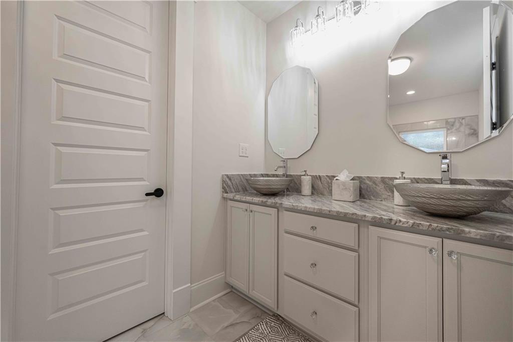 3667 Jones Mill Road Carrollton, GA 30116 - Photo 47 of 66 a bathroom with a double vanity sink and a mirror