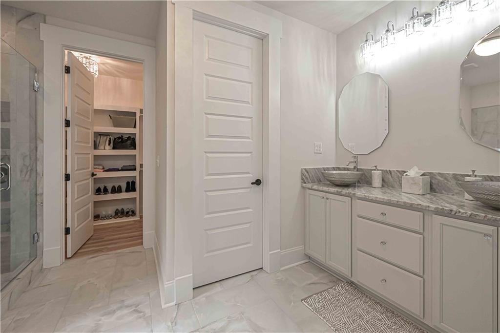 3667 Jones Mill Road Carrollton, GA 30116 - Photo 50 of 66 a bathroom with a double vanity sink and a mirror