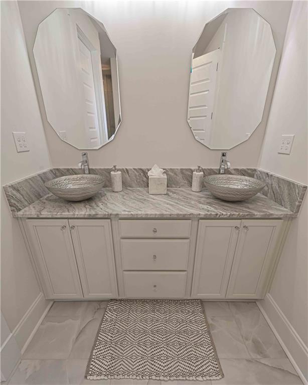 3667 Jones Mill Road Carrollton, GA 30116 - Photo 51 of 66 a bathroom with a granite countertop sink and a mirror