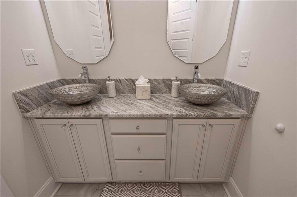 3667 Jones Mill Road Carrollton, GA 30116 - Photo 52 of 66 a bathroom with a granite countertop sink and a mirror