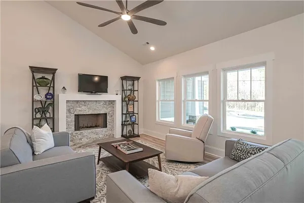 a living room with furniture ceiling fan and a rug