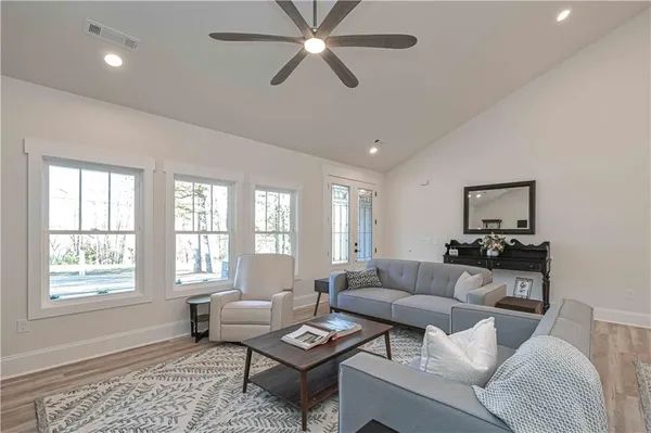a living room with furniture a fireplace and a flat screen tv