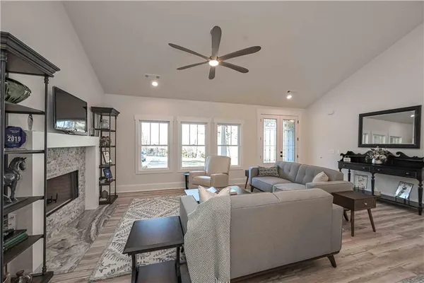 a living room with a fireplace and a flat screen tv