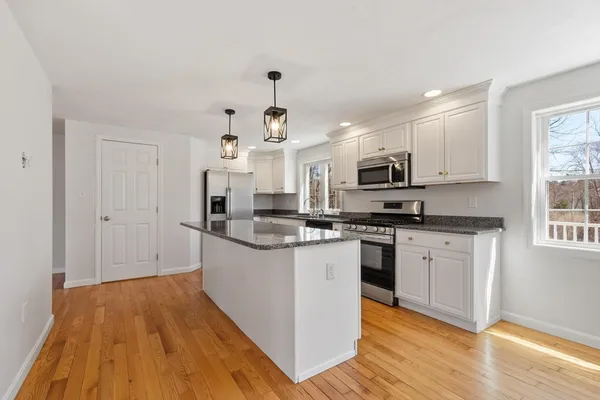 a kitchen with stainless steel appliances granite countertop a stove and a sink