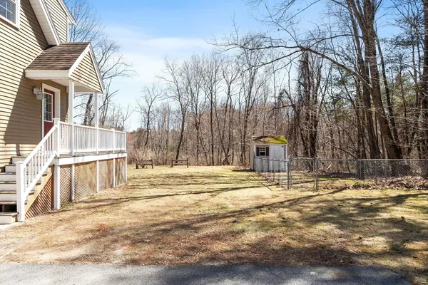 a view of a house with a yard and snow