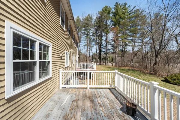 a view of a wooden balcony with a yard