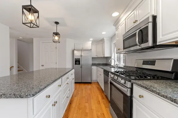 a kitchen with stainless steel appliances granite countertop a sink and stove