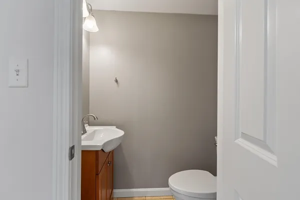a bathroom with a sink toilet and mirror