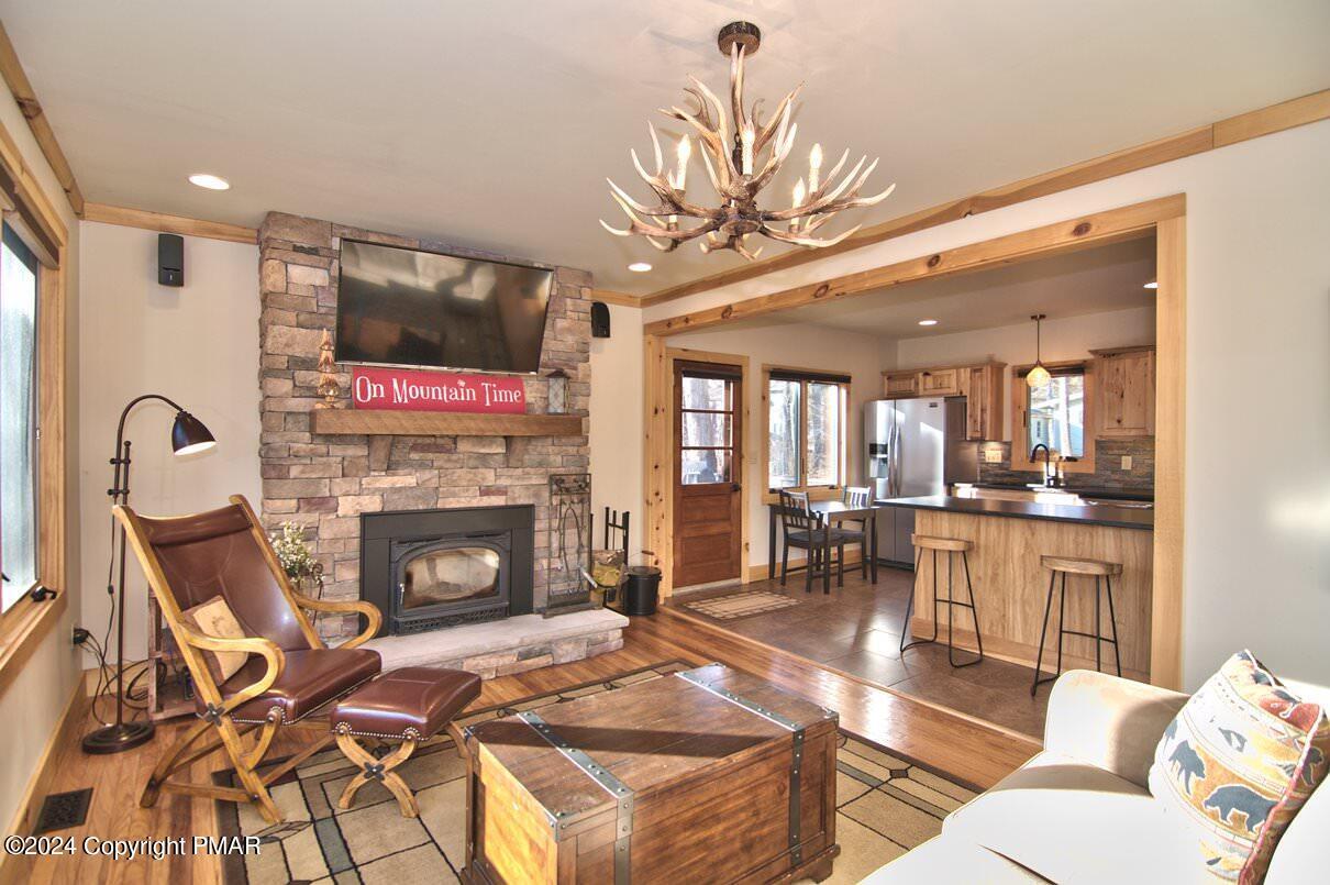 5187 Woodland Avenue Pocono Pines, PA 18350 - Photo 1 of 40 a living room with furniture a flat screen tv and a fireplace