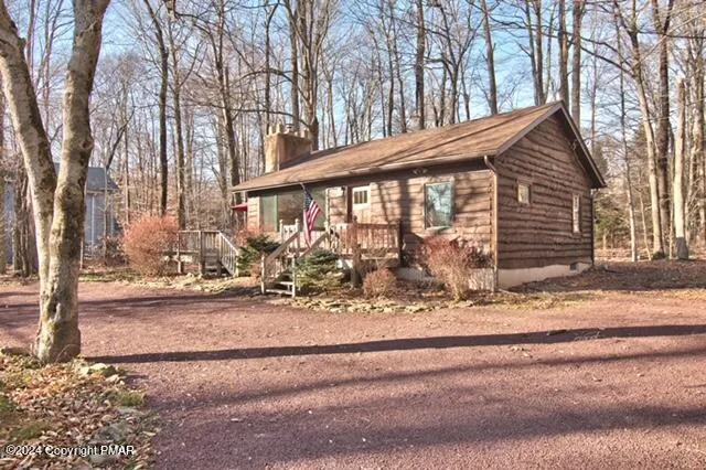 a view of a house with a yard and pathway