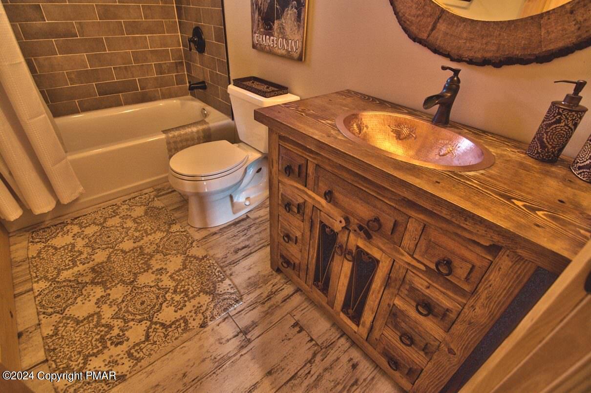 5187 Woodland Avenue Pocono Pines, PA 18350 - Photo 12 of 40 a bathroom with a sink and a mirror