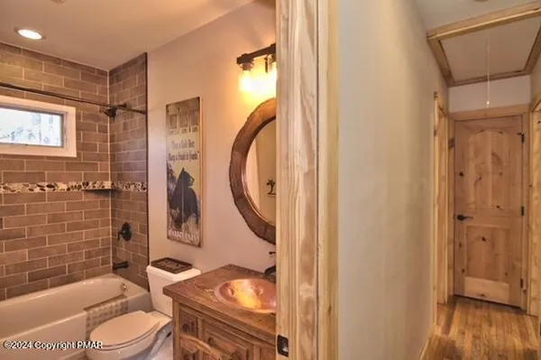 a bathroom with a granite countertop toilet sink and shower