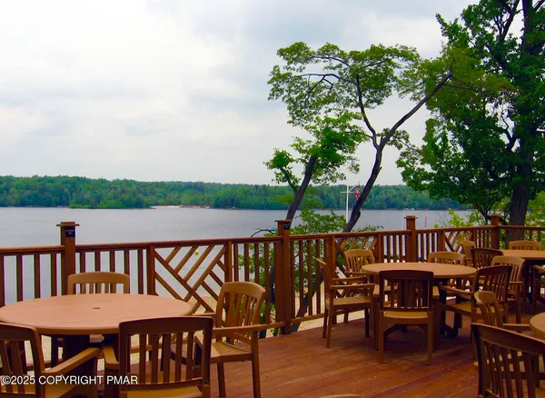 a view of a lake with a big yard and large trees