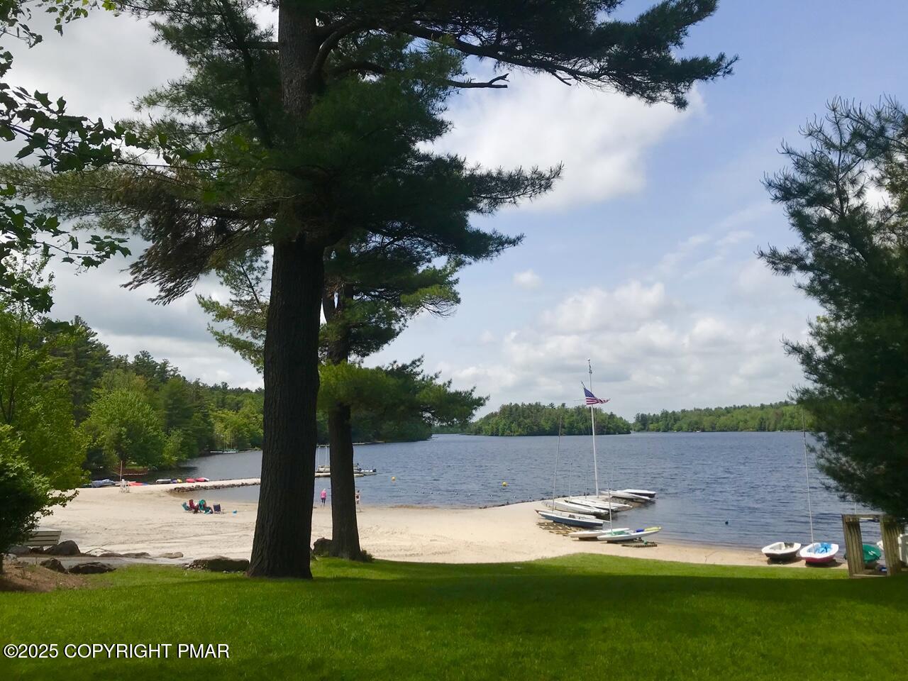 5187 Woodland Avenue Pocono Pines, PA 18350 - Photo 30 of 40 a view of a lake with a big yard and large trees