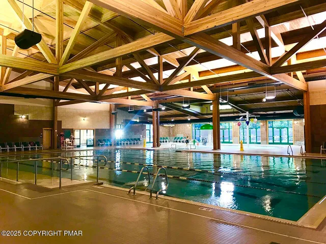 a living room with furniture a flat screen tv and a table