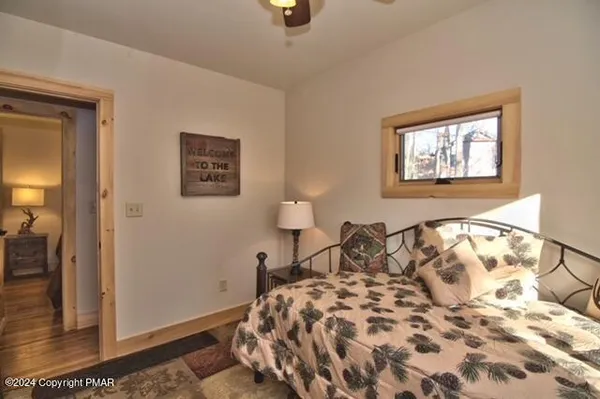 a bedroom with a bed and a painting on the wall