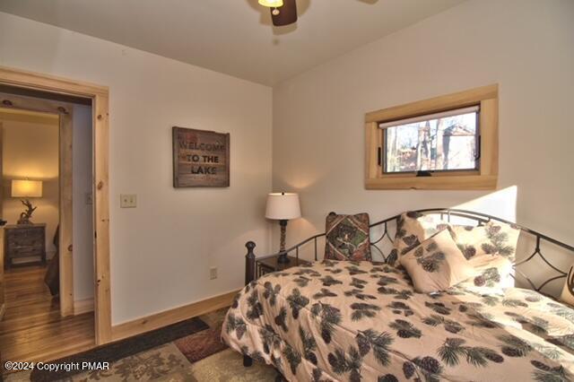 5187 Woodland Avenue Pocono Pines, PA 18350 - Photo 4 of 40 a bedroom with a bed and a painting on the wall