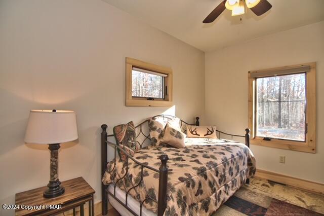 5187 Woodland Avenue Pocono Pines, PA 18350 - Photo 5 of 40 a bedroom with a bed and a lamp on table