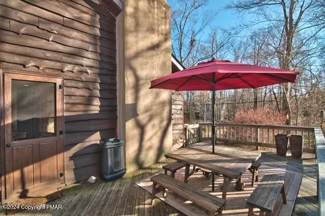 a view of balcony with wooden floor and outdoor seating