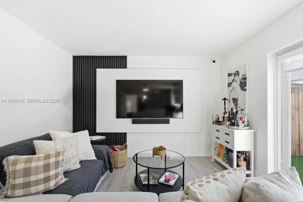 a living room with furniture and a flat screen tv