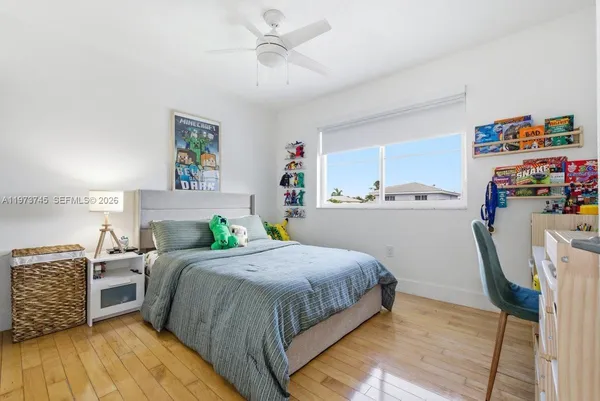 a bedroom with a bed and a view of kitchen