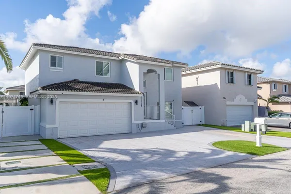a front view of a house with a yard and garage