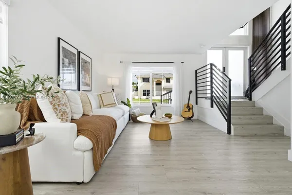 a living room with furniture and wooden floor