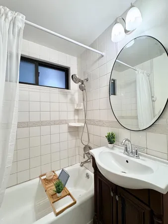 a view of a backyard with plants and large trees