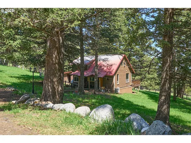 a backyard of a house with table and chairs