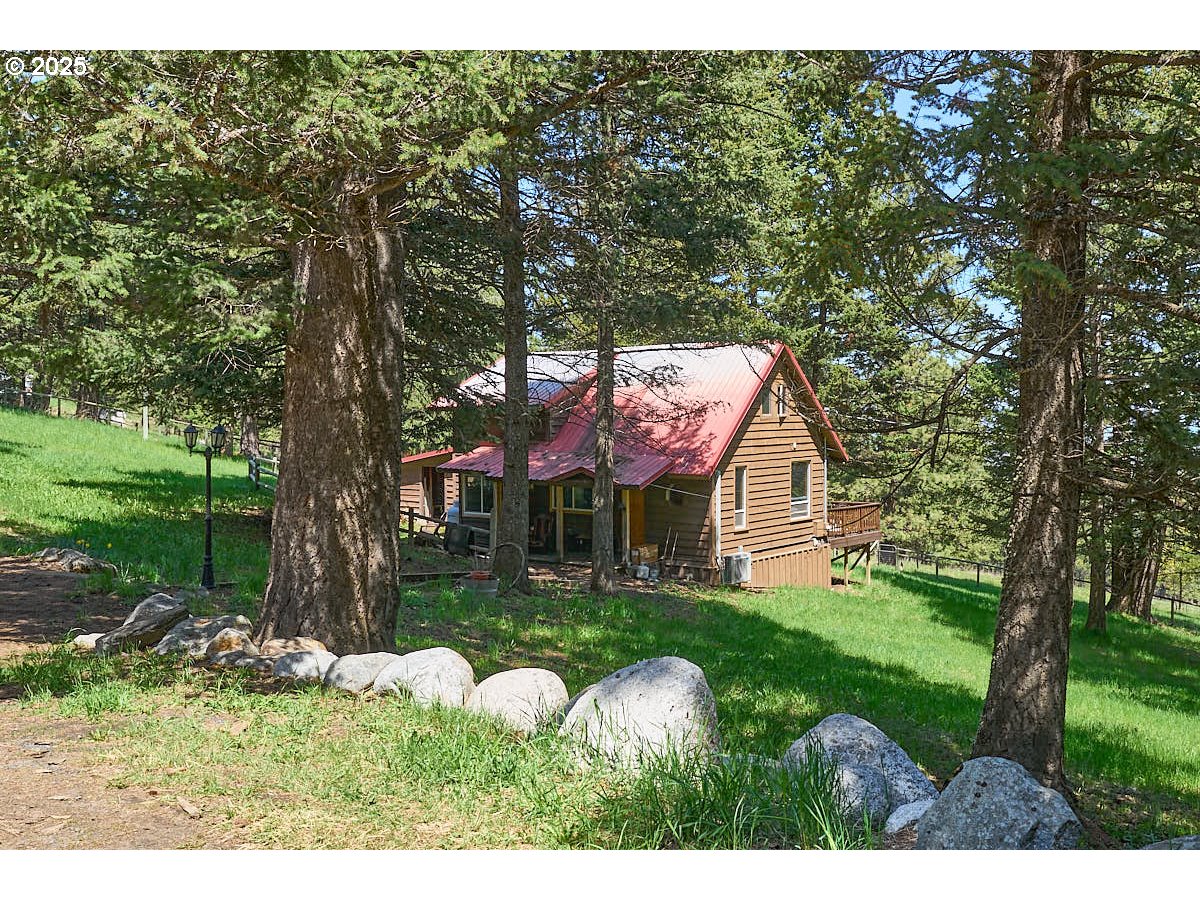 a backyard of a house with table and chairs