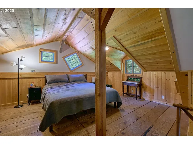 a bedroom with a bed closet and a mirror