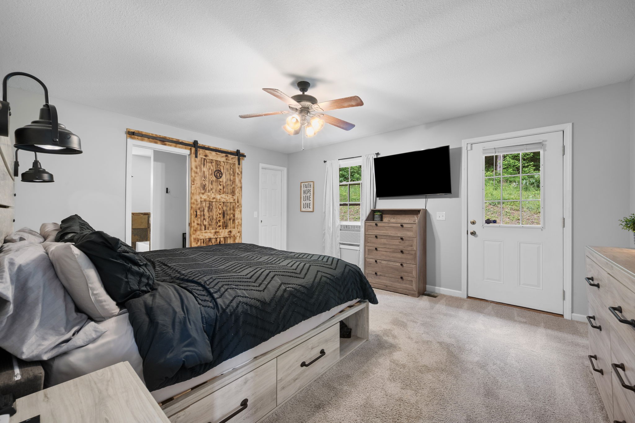 1197 Biter Road Cunningham, TN 37052 - Photo 14 of 38 a bedroom with a bed and a flat screen tv