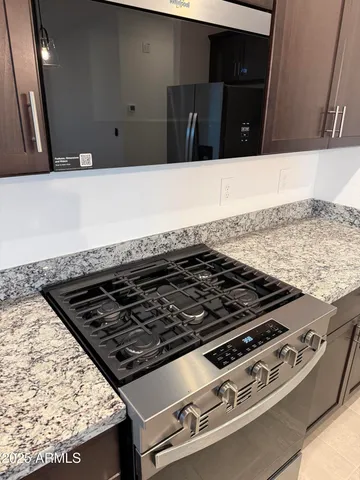 a close view of a stove a microwave and counter space