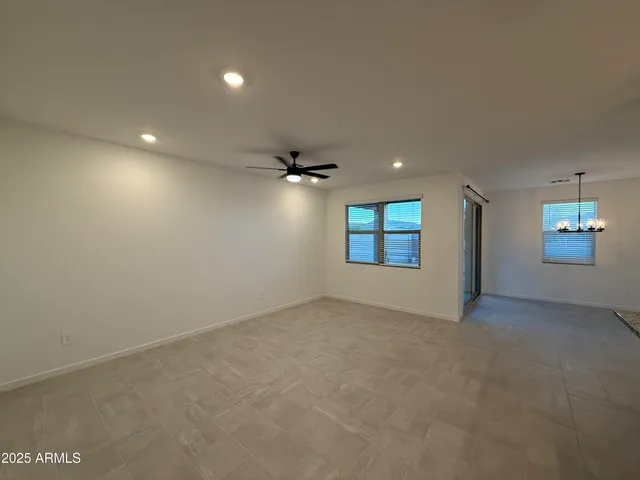 an empty room with windows and fireplace