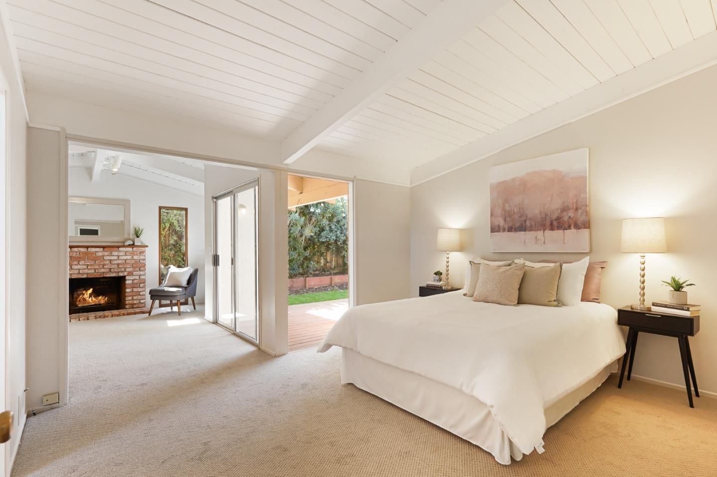 3955 Bibbits Drive Palo Alto, CA 94303 - Photo 24 of 42 a bedroom with a large bed and a fireplace