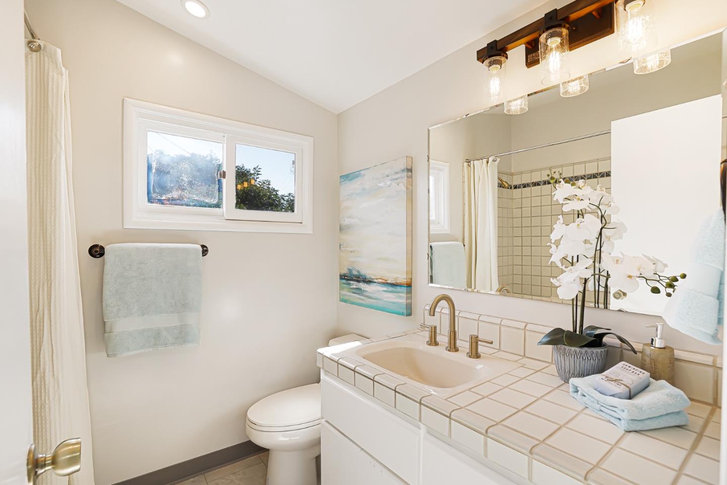 3955 Bibbits Drive Palo Alto, CA 94303 - Photo 35 of 42 a bathroom with a toilet a sink and a large mirror