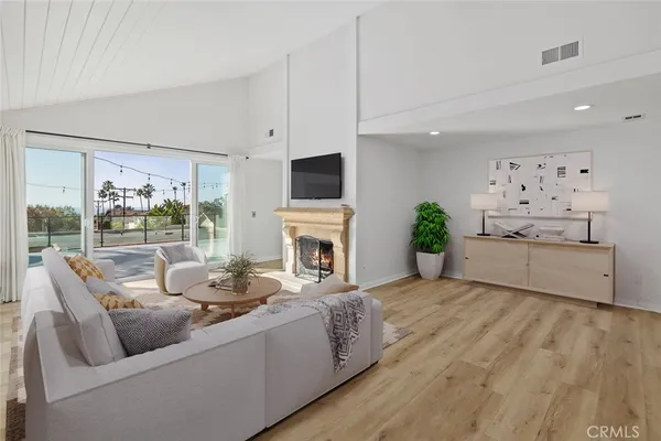 a living room with furniture fireplace and a large window