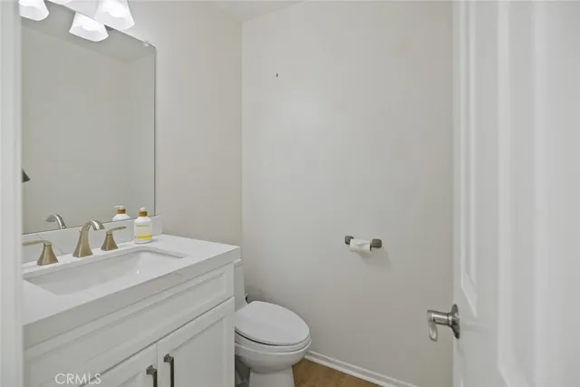 a bathroom with a sink mirror and toilet