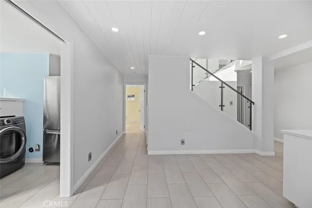 a view of a hallway with washer and dryer
