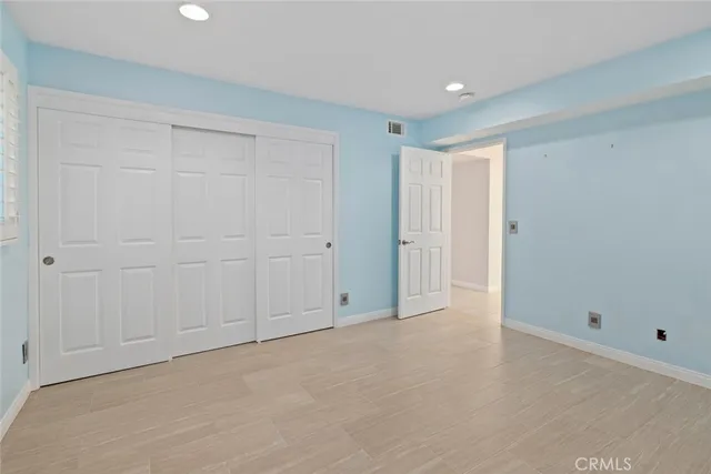 a bathroom with a granite countertop sink mirror vanity and toilet