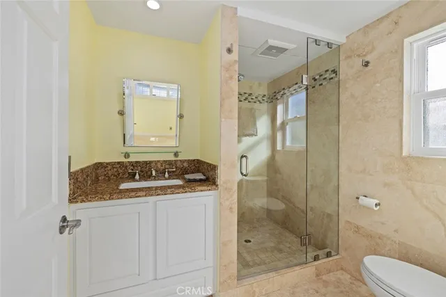 a spacious bathroom with a sink a mirror and shower