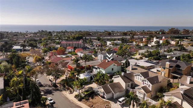 an aerial view of a houses with ocean view