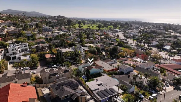 an aerial view of a houses with ocean view